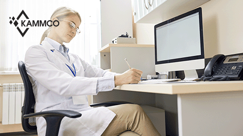 doctor taking notes at a desk