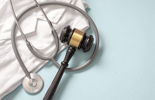 lab coat displayed with stethoscope and gavel